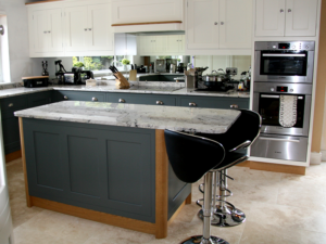 This striking Classy Reflection Kitchen is achieved with two complimenting Farrow & Ball colours with distinctive oak accents and mirror splashback.