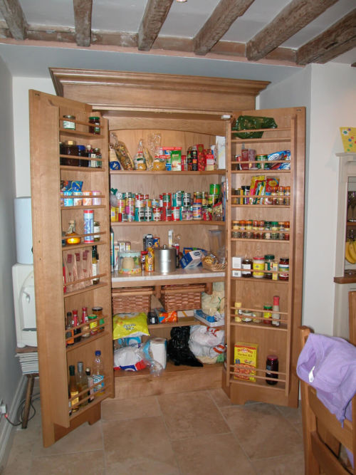 Oak Pantry cupboard with marble cold shelf, wicker baskets and storage sledges to rear of doors to hold all your essentials.